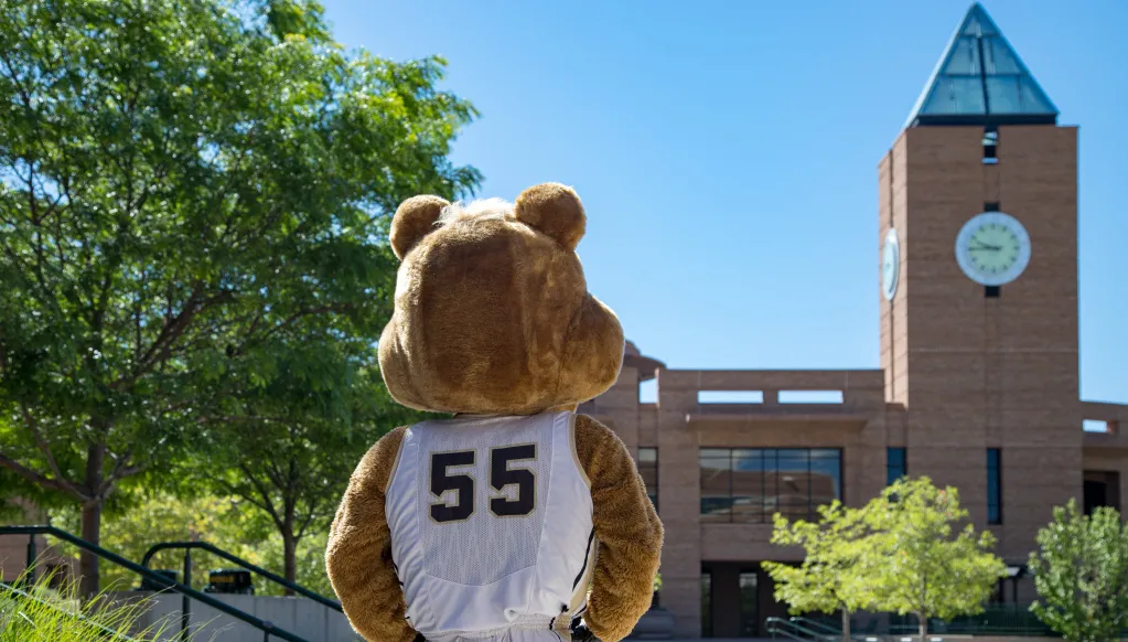 Clyde, the UCCS Mascot, facing away from the camera, looking off on campus