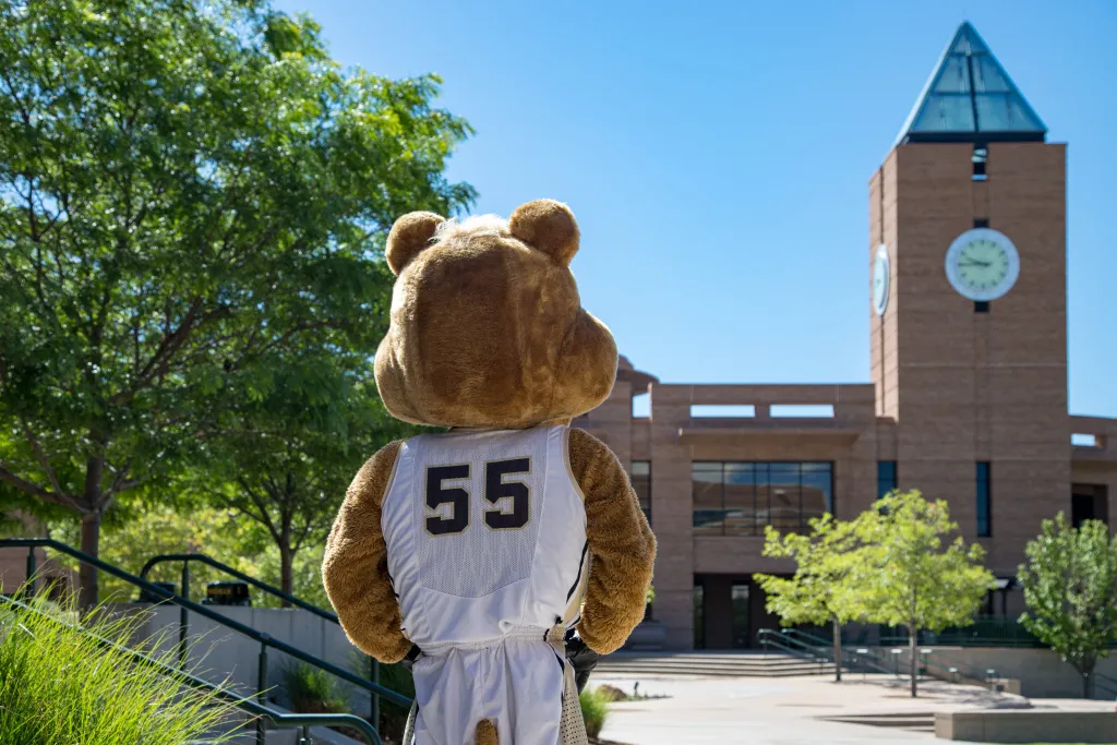 Clyde, the UCCS Mascot, facing away from the camera, looking off on campus